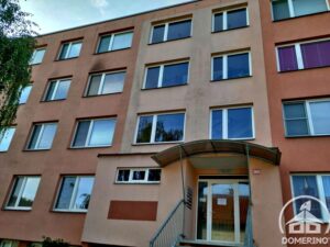 Fasáda panelového domu v Praze 6 znečištěná plísní